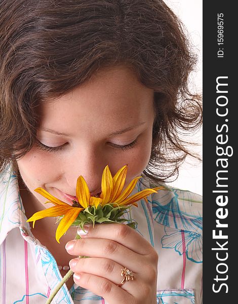 Woman sniffs sunflower