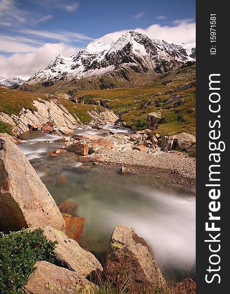 Gavia Pass, Brixia province, Lombardy region, Italy. Gavia torrent at 2651 meters on the sea-level. Tresero peak as background