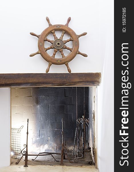 A wheel helm on a fire place