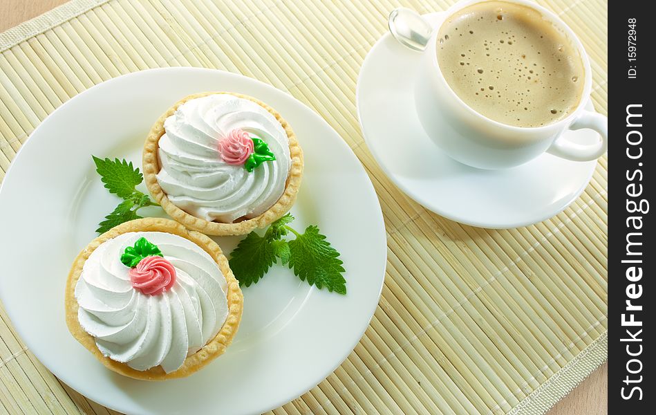 Coffee and two small cakes  with mint. Coffee and two small cakes  with mint