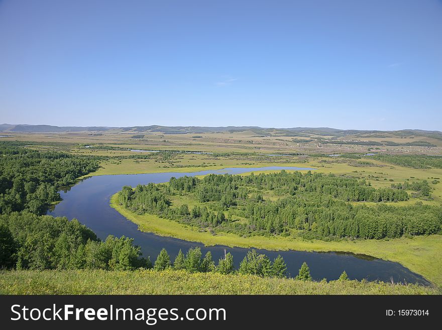 The curving river in the summer prairies of Inner Mongolia, China. The curving river in the summer prairies of Inner Mongolia, China