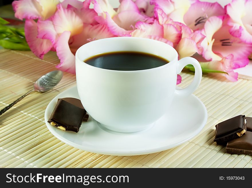 Black coffee in white cup with chocolate
