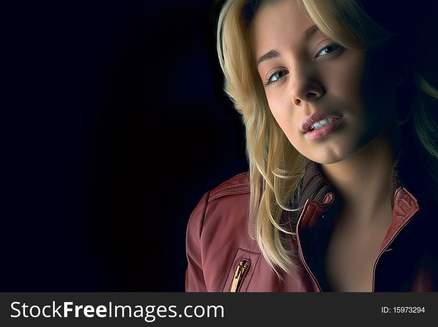 Young beautiful girl in red leather jacket