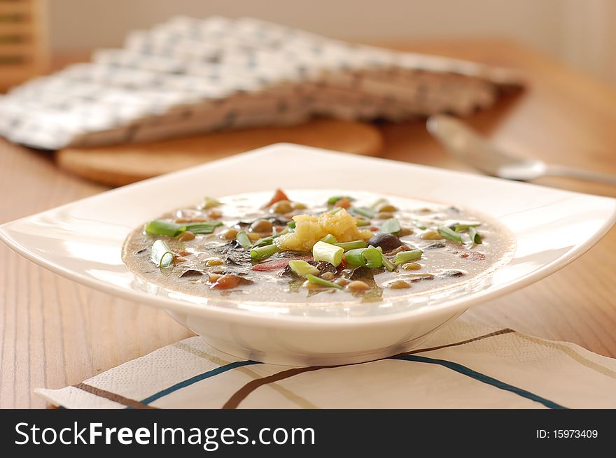 Mushroom soup with garlic and onion served on a white plate