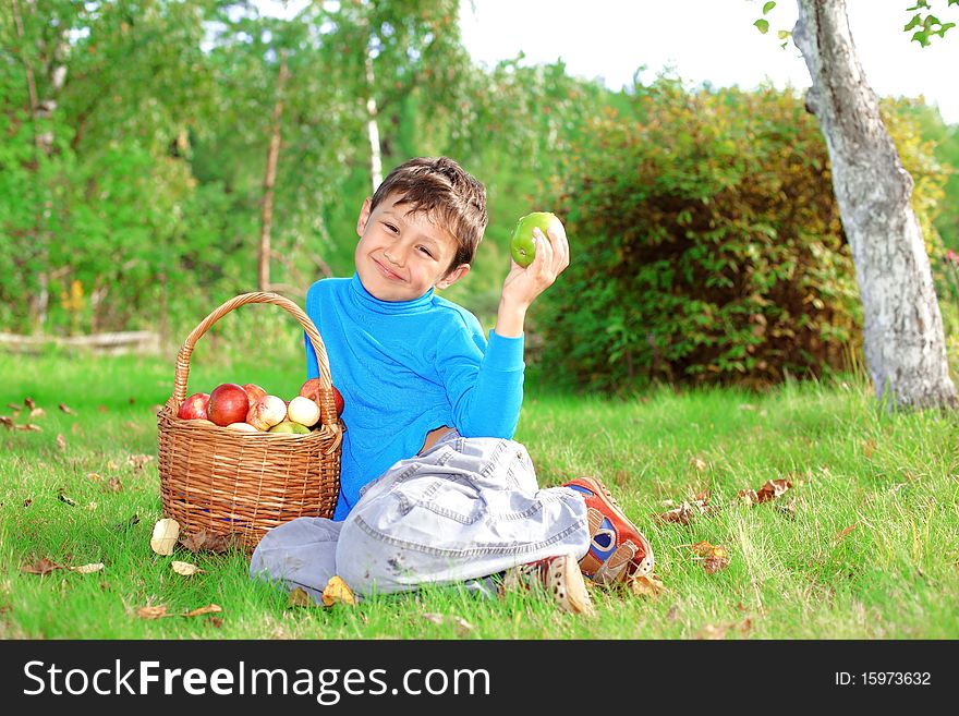 Little boy posing outdoors with apples. Little boy posing outdoors with apples