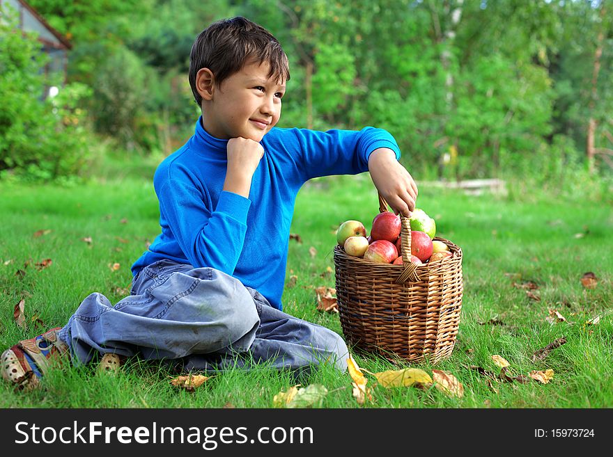 Harvest time - little boy posing outdoors with apples. Harvest time - little boy posing outdoors with apples