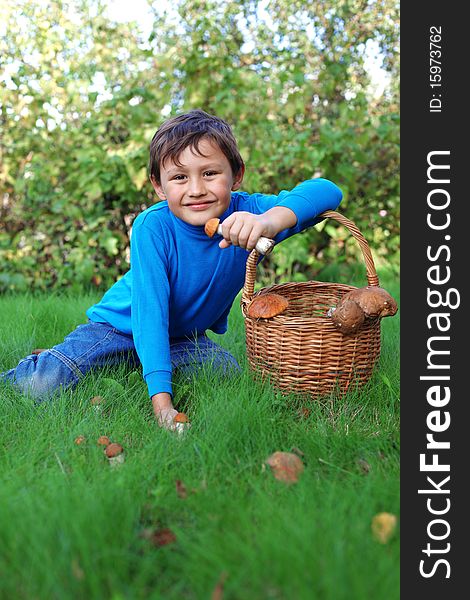 Little boy posing outdoors with mushrooms. Little boy posing outdoors with mushrooms