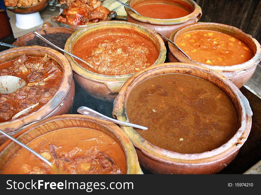 Variety of Guatemalan meat gravies, displayed in traditional earthen bowls. Variety of Guatemalan meat gravies, displayed in traditional earthen bowls.