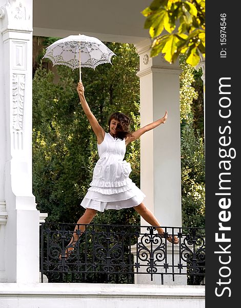 Happy young woman  jumping  with white sun umbrella. Happy young woman  jumping  with white sun umbrella
