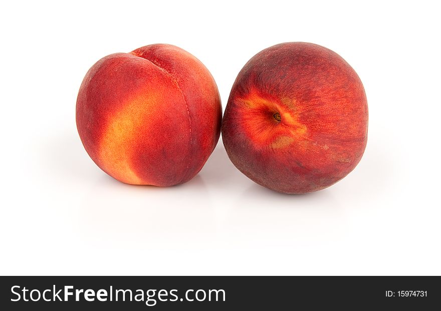 Two juicy peaches isolated on white background
