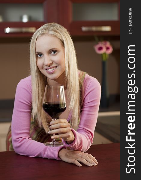 Young attractive woman tasting red wine before dinner. Young attractive woman tasting red wine before dinner