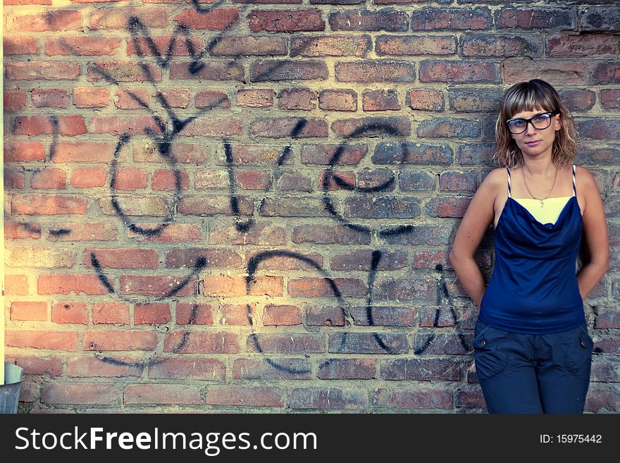 Snapshot beautiful girl. The background for the portrait is a brick wall with the inscription I love you