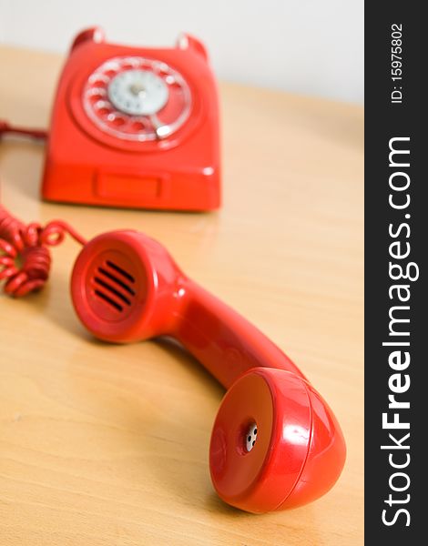 Vintage red telephone on wooden table