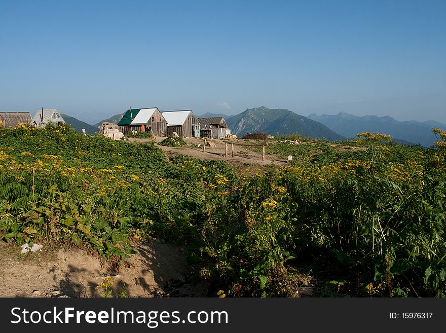 Nice view of small village in the West Caucasus. The summer houses of local residents. Nice view of small village in the West Caucasus. The summer houses of local residents