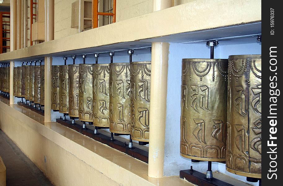 Buddhist prayer wheels in bright red with mantra written all over