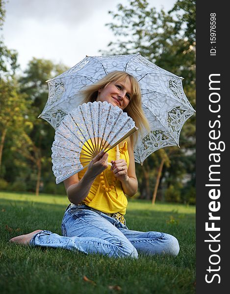 A girl with an umbrella and a fan