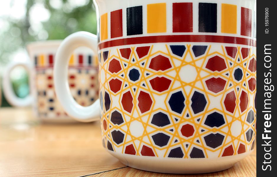 Two bright patterned cups on the table. Two bright patterned cups on the table