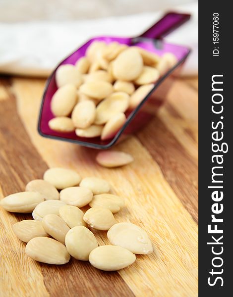 Almonds in a bowl and a wooden table