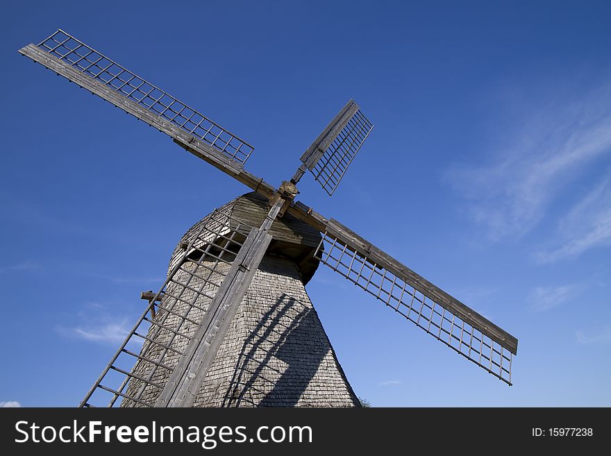 Old wooden windmill against the blue sky