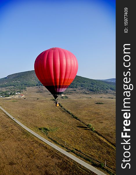 Red air balloon near road