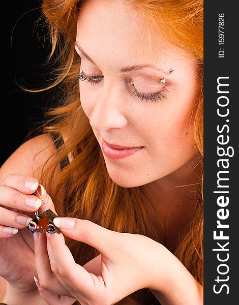 Red-haired woman with a butterfly, closeup. Red-haired woman with a butterfly, closeup