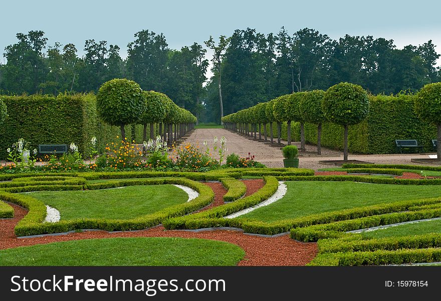 Avenue and ber or flowers in formal garden. Avenue and ber or flowers in formal garden