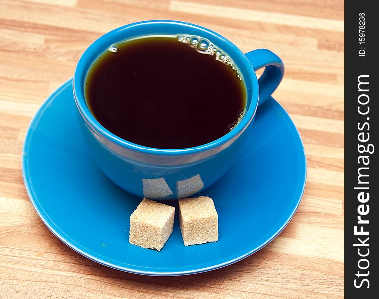 Hot cup of tea and sugar cubes