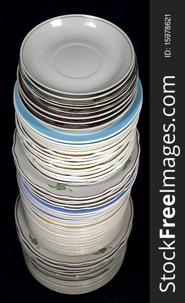 Pile of plates on a black background. Pile of plates on a black background.