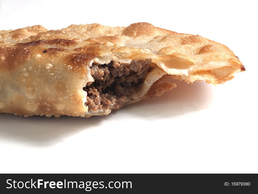 Close up view of a Meat Turnover pie isolated on white.