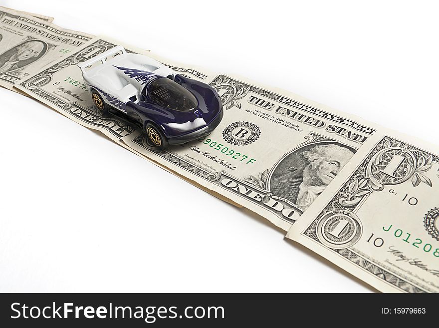 Toy sport car moving on dollar banknotes. Toy sport car moving on dollar banknotes.