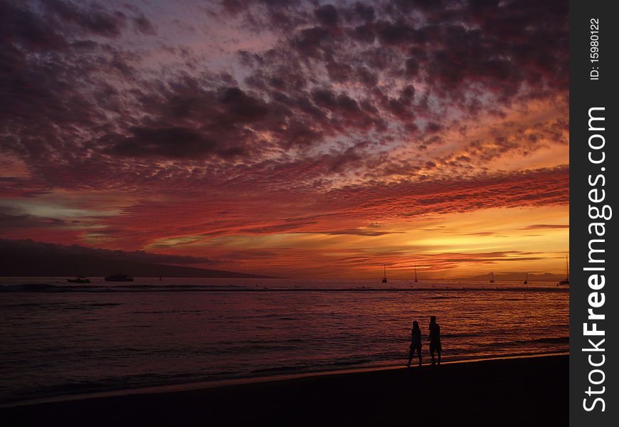 Couple walking on sunset beach. Couple walking on sunset beach