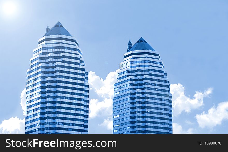 Two buildings  on a background of the blue sky. Two buildings  on a background of the blue sky