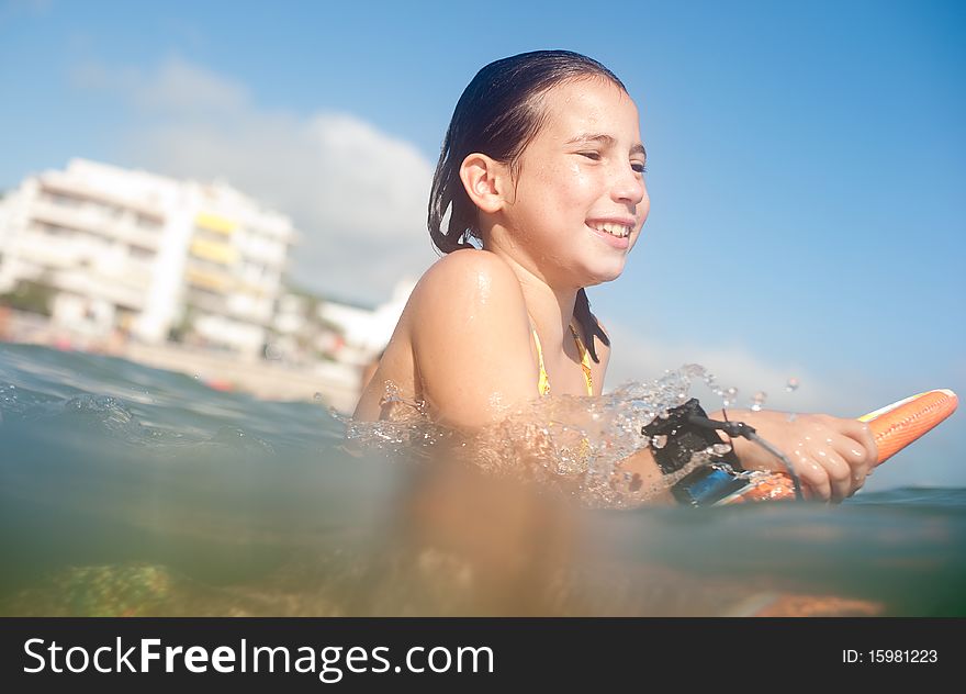 Girl surfing in the beach