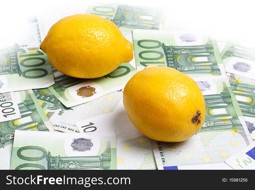 Lemons lying on 100 euro banknotes