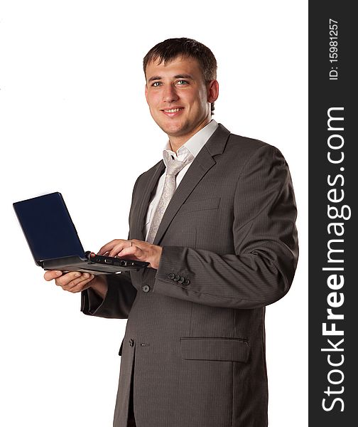 Happy young businessman using laptop. Happy young businessman using laptop