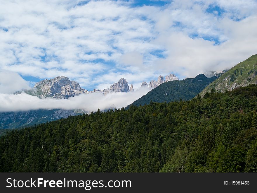 Trentino mountain scenery with mountains and clouds in a summer day