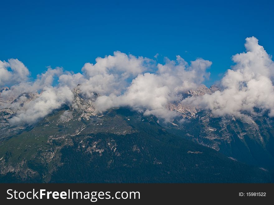 Trentino mountain scenery with mountains and clouds in a summer day