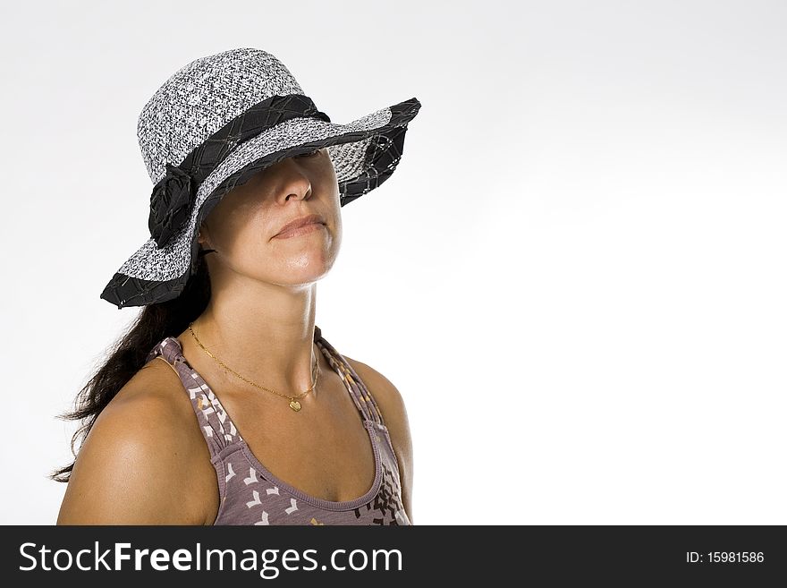 Fashion girl in a big hat in the studio. Fashion girl in a big hat in the studio