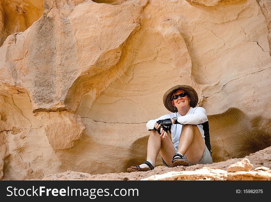 Woman cooling off and relaxing in shade in the desert