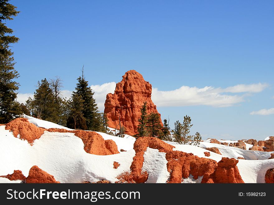 Red rock formation in the forest during the winter in Utah. Red rock formation in the forest during the winter in Utah