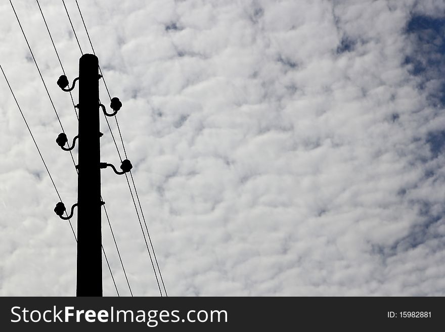 Electrical tower on a background of the clowdy sky