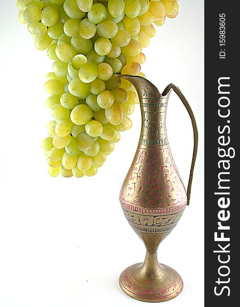 White grapes and stone jug isolated on a white background