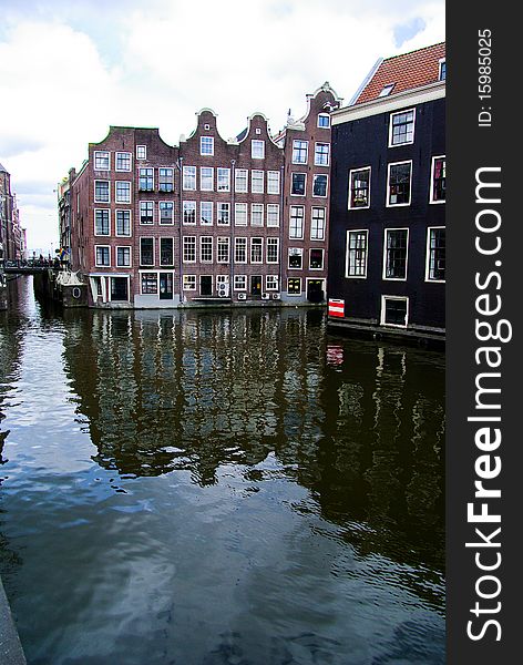 Water canal with houses in Amsterdam, Holland