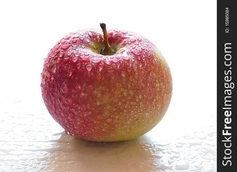 Fresh red apple with drops of water