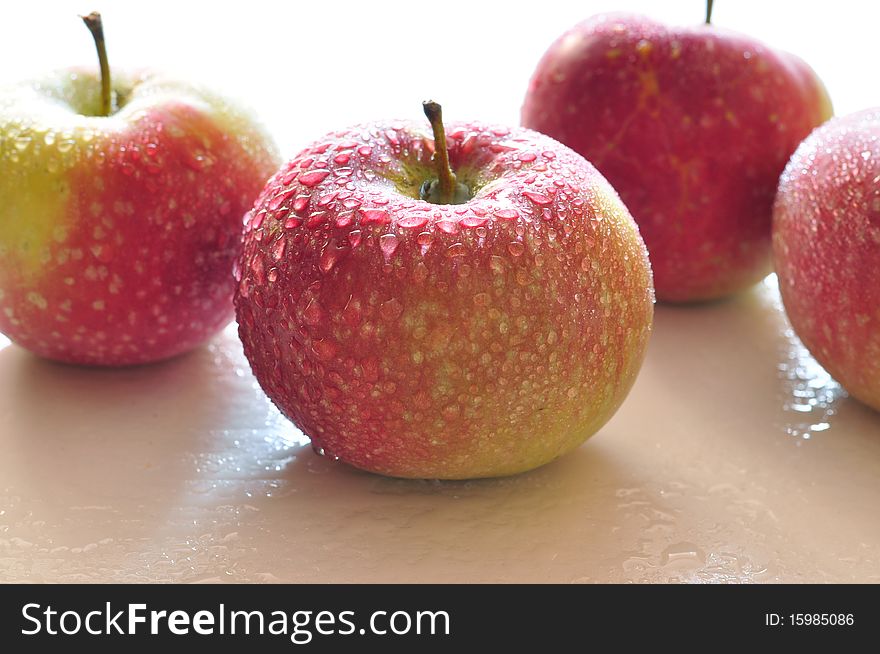 Fresh red apples with drops of water