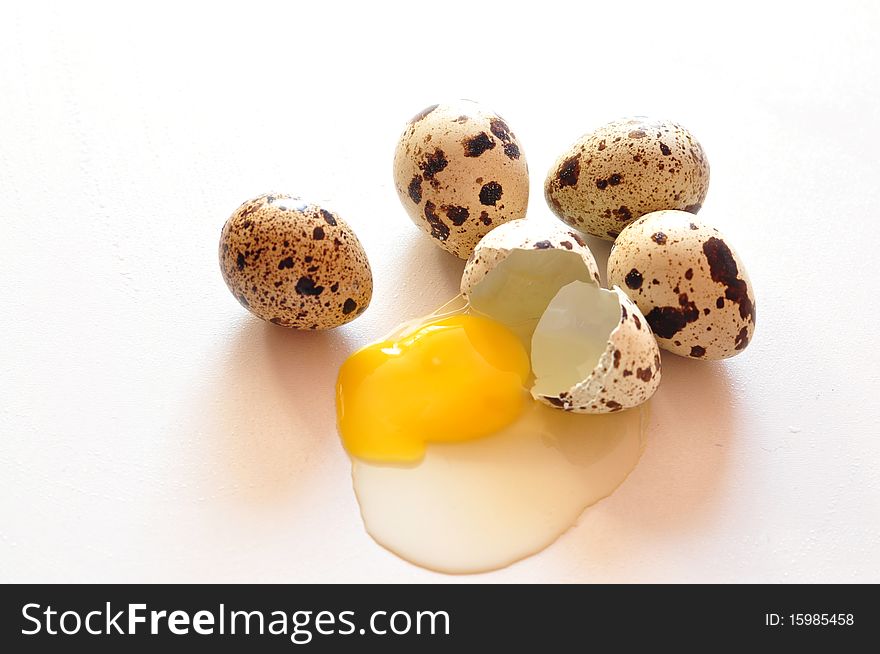 A few quail eggs and one broken. A few quail eggs and one broken