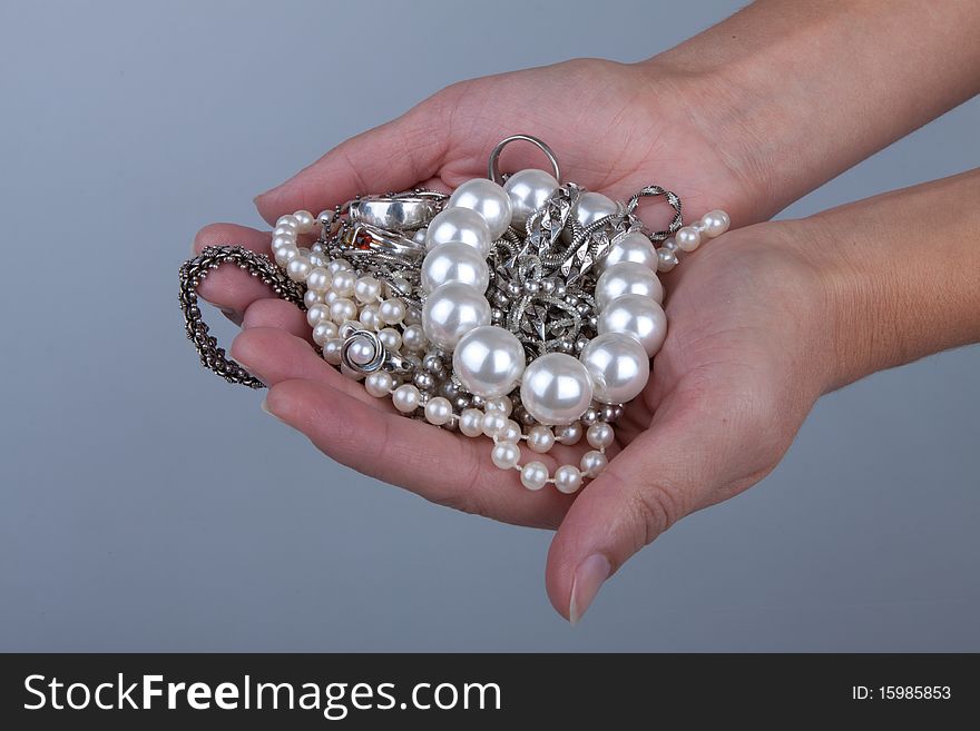 Jewelry in female hands, pearls ans silver