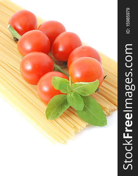 Spaghetti with tomatos and basilikum on a white background