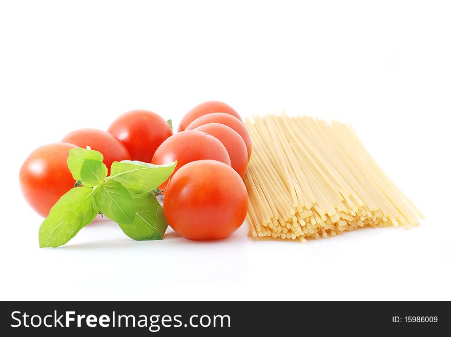 Spaghetti with tomatos and basilikum on a white background