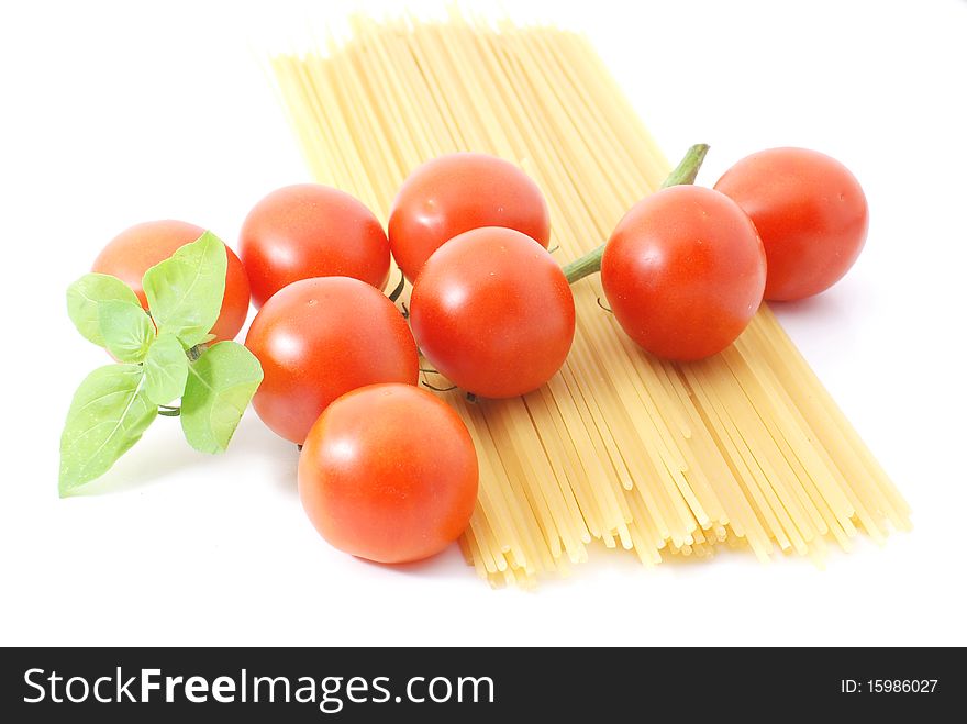 Spaghetti with tomatos and basilikum on a white background